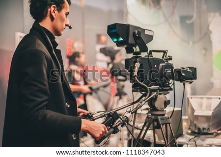 Behind the scene. Multiple camera setup. Cameraman shooting the film scene with camera in film studio. Group cinema set