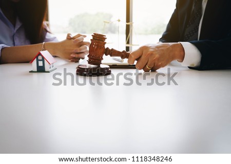 Businesswoman and male lawyers having a meeting at a law firm. Home loan insurance, lawyer or judge Law and justice concept. Real Estate Law concept Royalty-Free Stock Photo #1118348246