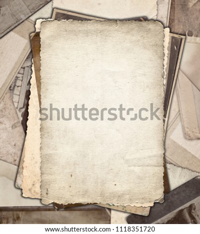 Vintage photo paper on heap of old photos background