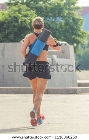 girl athlete summer day, running in the Park