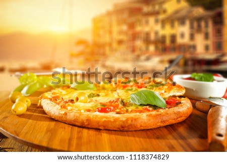 Fresh hot pizza and italy landscape 