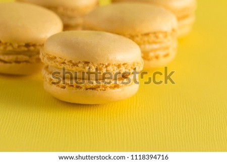Yellow French Macarons on a Yellow Background