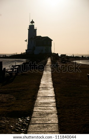 Dutch Lighthouse in the winter picture made against the sunlight