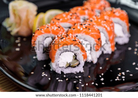 photo of Japanese rolls in a black plate