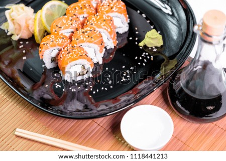 photo of Japanese rolls in a black plate