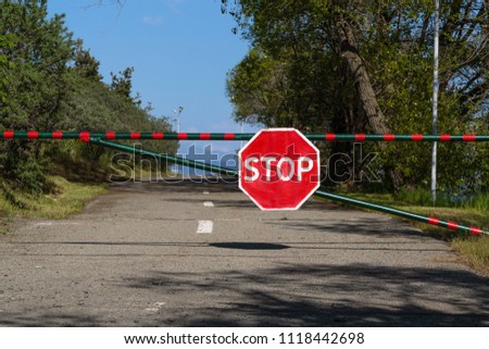 stop sign on the barrier in the daytime