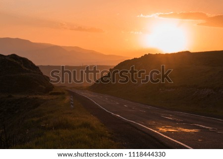 road near the hills in the evening