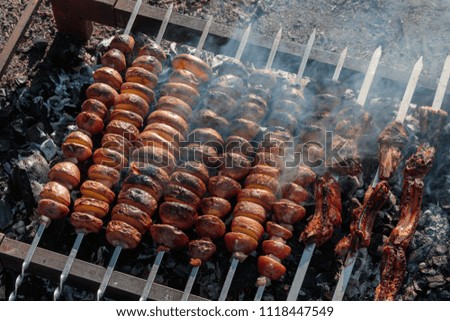 meat and potatoes are fried on the grill