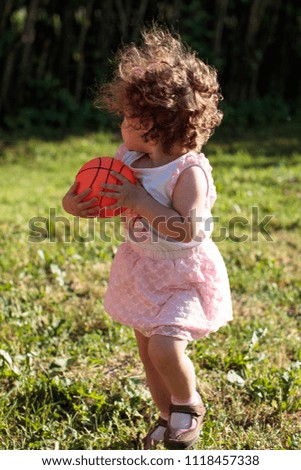 little baby girl holding hands little basketball