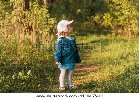 little baby girl alone in nature in the daytime