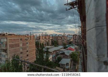 multi storey houses against the blue sky and white clouds
