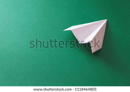 paper plane on green background. transportation concept