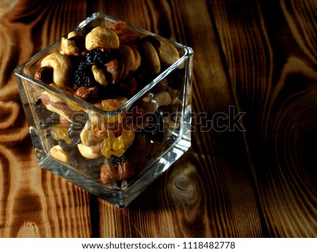 Different nuts with raisins in a glass