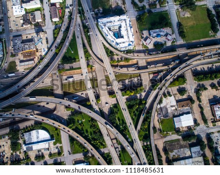 Traffic highways interstate and interchange , loops and turn arounds transportation roads in massive crowded populated Houston , Texas , USA a crowded big city gulf coast of Texas straight down angle