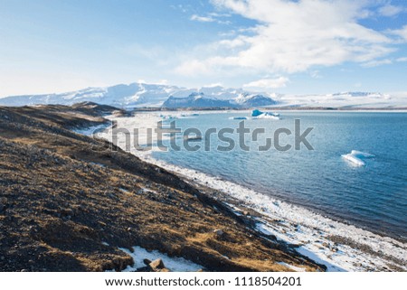 Panoramic view of a beautiful cold winter landscape with icebergs in Jökulsárlón glacial lagoon, Vatnajökull National Park, southeast of Iceland, Europe.