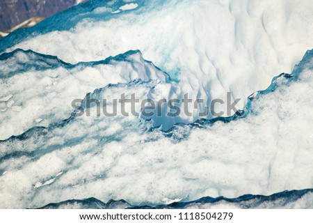 Beautiful cold winter landscape with icebergs in Jökulsárlón glacial lagoon, Vatnajökull National Park, southeast of Iceland, Europe. Close up of icebergs, rocks and sheets of ice.