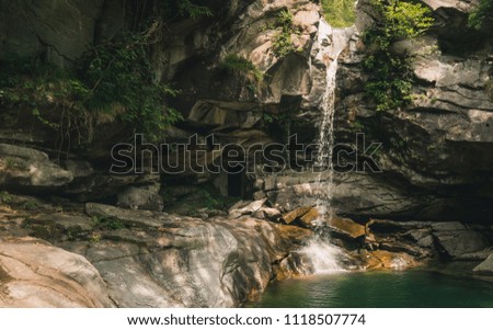 Jump to the water in Switzerland in the mountains. At the waterfall to the ice creek. Osogna Ticino Switzerland