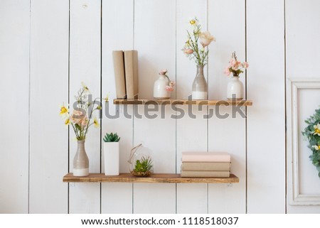 shelf with flowers and books Royalty-Free Stock Photo #1118518037
