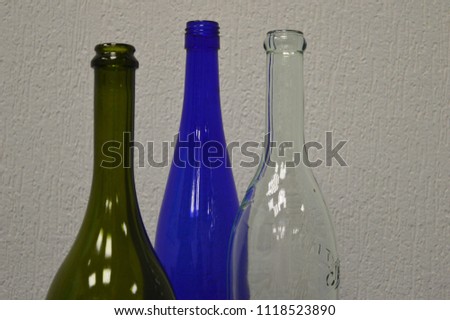 Three different forms of colorful bottles with reflections