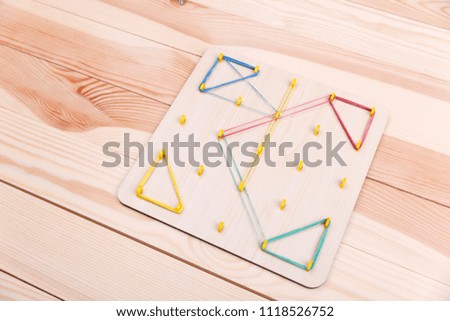 A wooden board with hooks