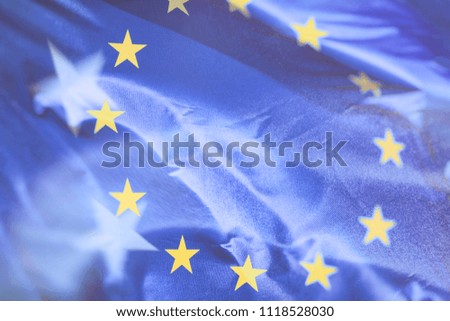 Flag of the European Union which waving in the wind on sunny day, background, close-up, double exposure photo