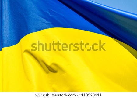 Flag of Ukraine which waving in the wind on sunny day, background, close-up