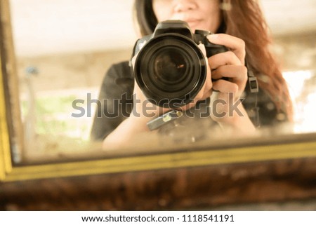 Blurry portrait woman with camera,Asian woman