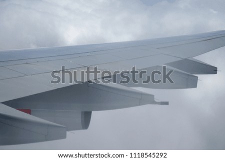 Wing of an airplane with clouds. Picture to add text message or frame for website. Traveling concept.