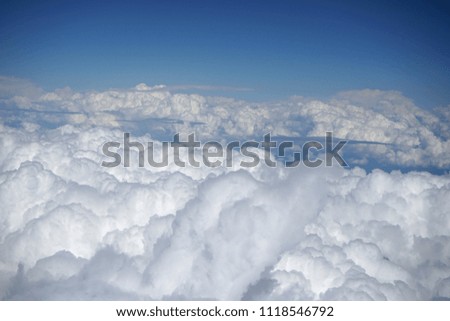 Above the Clouds from airplane. Picture taken from inside airplane from passenger seat.