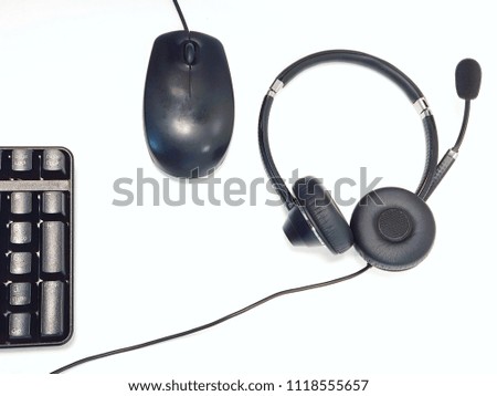 Black headphone,  mouse and keyboard on white background