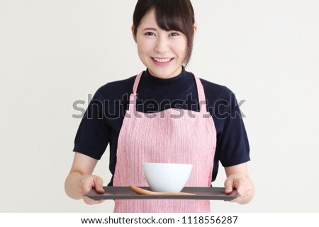 young woman with apron bowl of boiled rice isolated on white background