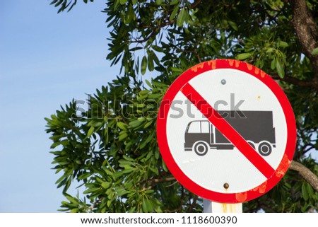 No Heavy Trucks Sign against Cloudy Blue Sky Background
