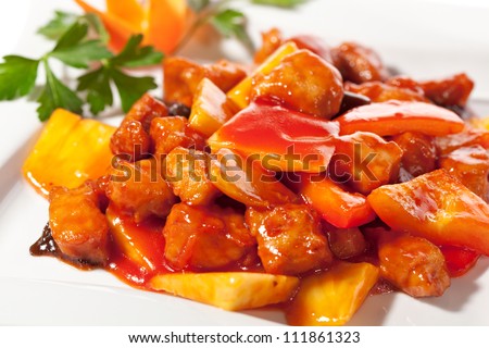 Chinese Cuisine - Pork with Pineapple Deep Fried in  Sour-Sweet Sauce Royalty-Free Stock Photo #111861323