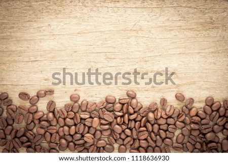 Coffee beans on old wood background