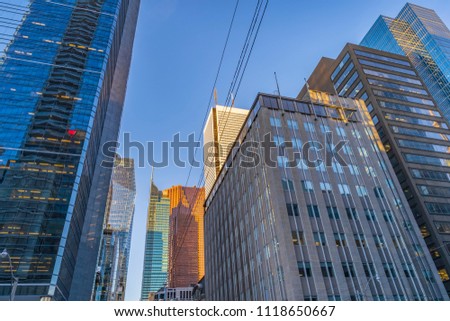 Skyscrapers in the Financial District of  Toronto from below and streetcar power lines crossing the street