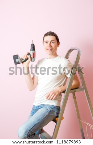 Image of man with drill near ladders