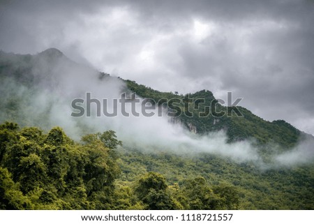 Foggy mountain and dramatic sky