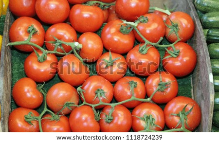 box of big and juicy red tomatoes for sale at a local market stall