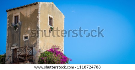 Traditional old Sicilian house during a sunny day with a wonderful blue sky background.