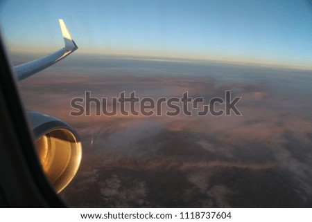 Airplane in flight in the sky above the clouds