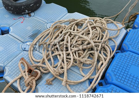 Pile of ship rope on floating pontoon.