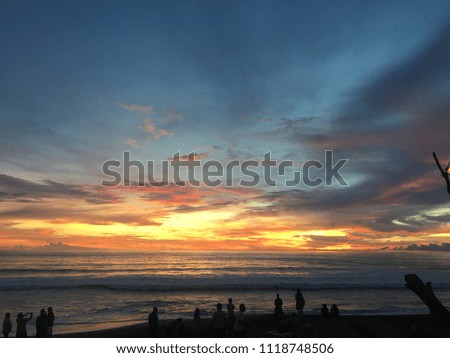 Landscape sunset of paradise Bali island beach, people enjoy sunset