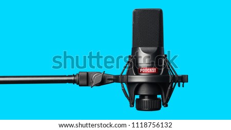 Studio microphone for recording podcasts over blue background Royalty-Free Stock Photo #1118756132