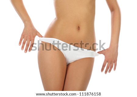 Young, fit girl in her underwear preparing to take off her panties and showing her waist close up