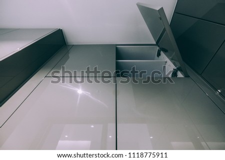 grey color of hi-gloss panel; a door is left open.
