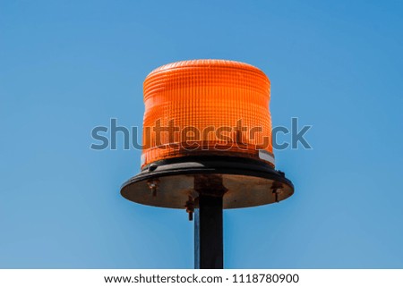 orange flasher is isolated on blue sky. close up.
