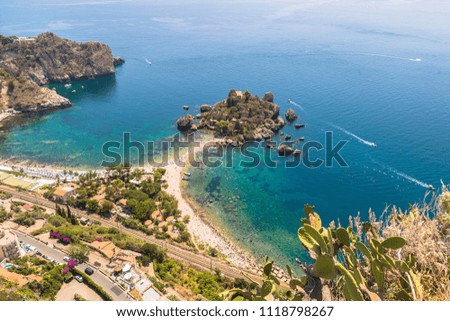 Aerial view of island and Isola Bella beach and blue ocean water in Taormina