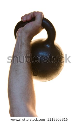 Heavy weight in a human hand on a white background. Sport.