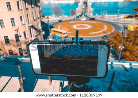 smartphone taking pictures of roundabout traffic