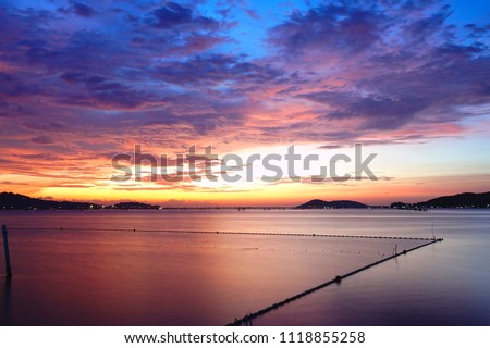 Long exposure shot of Lake view at Southern Thailand on sunset time background,Long exposure shot lake view with colored sky over lake on sunset time background.                        

